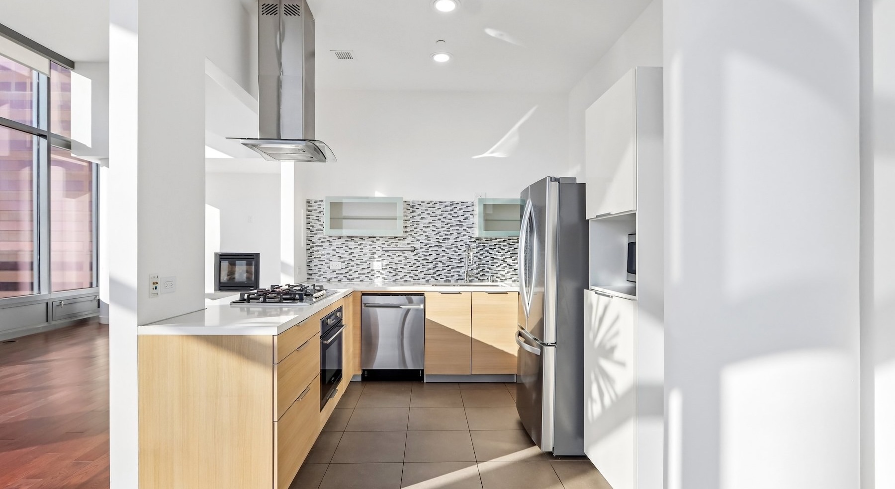 a kitchen with white and wood cabinets