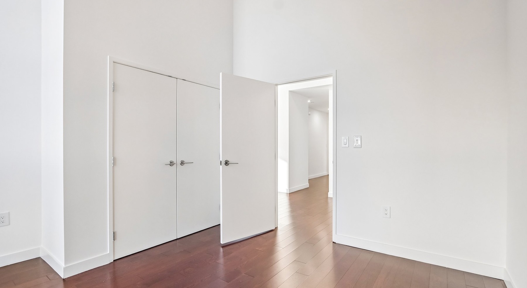 a room with white walls and wood floors