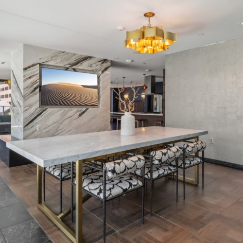 a room with a table, chairs and a tv