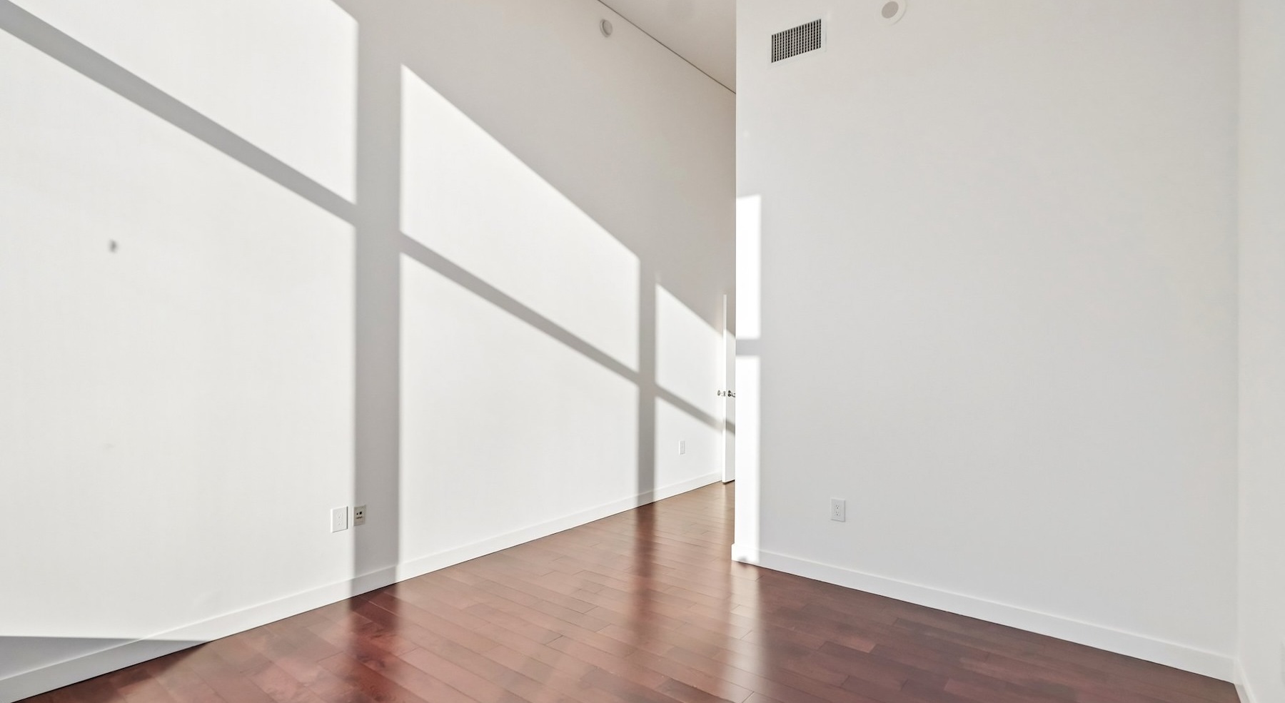 a room with white walls and wood floors