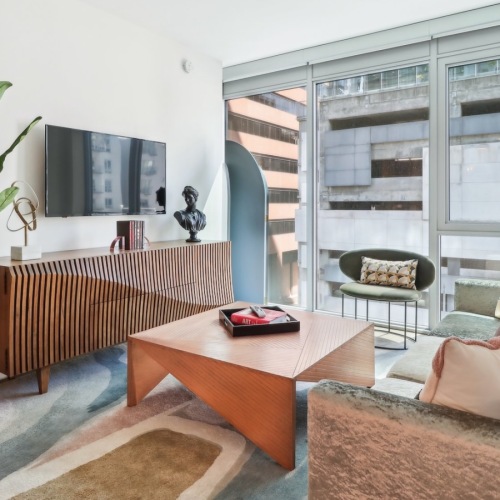 a living room with a couch, tv and tables