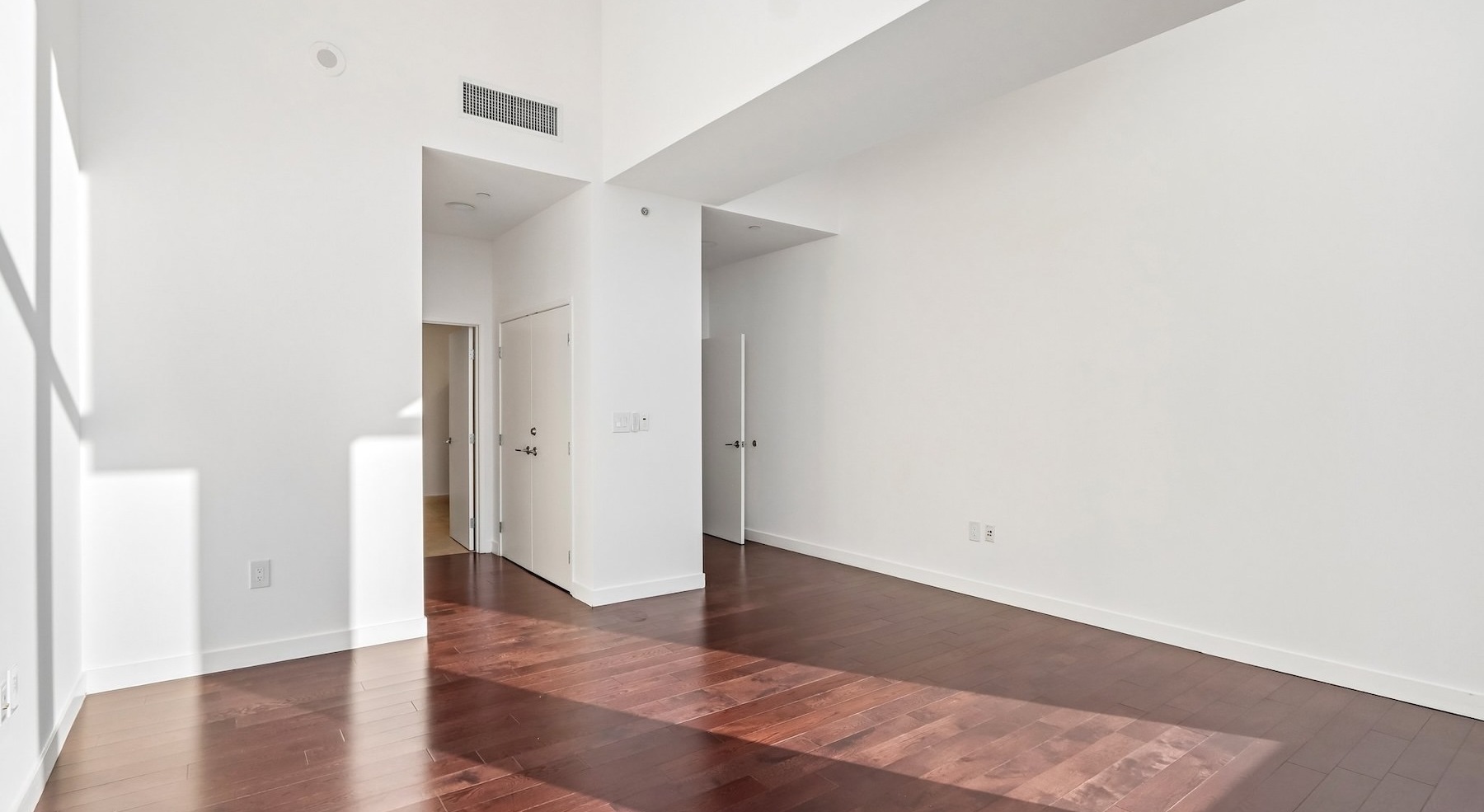 a room with white walls and wood floors