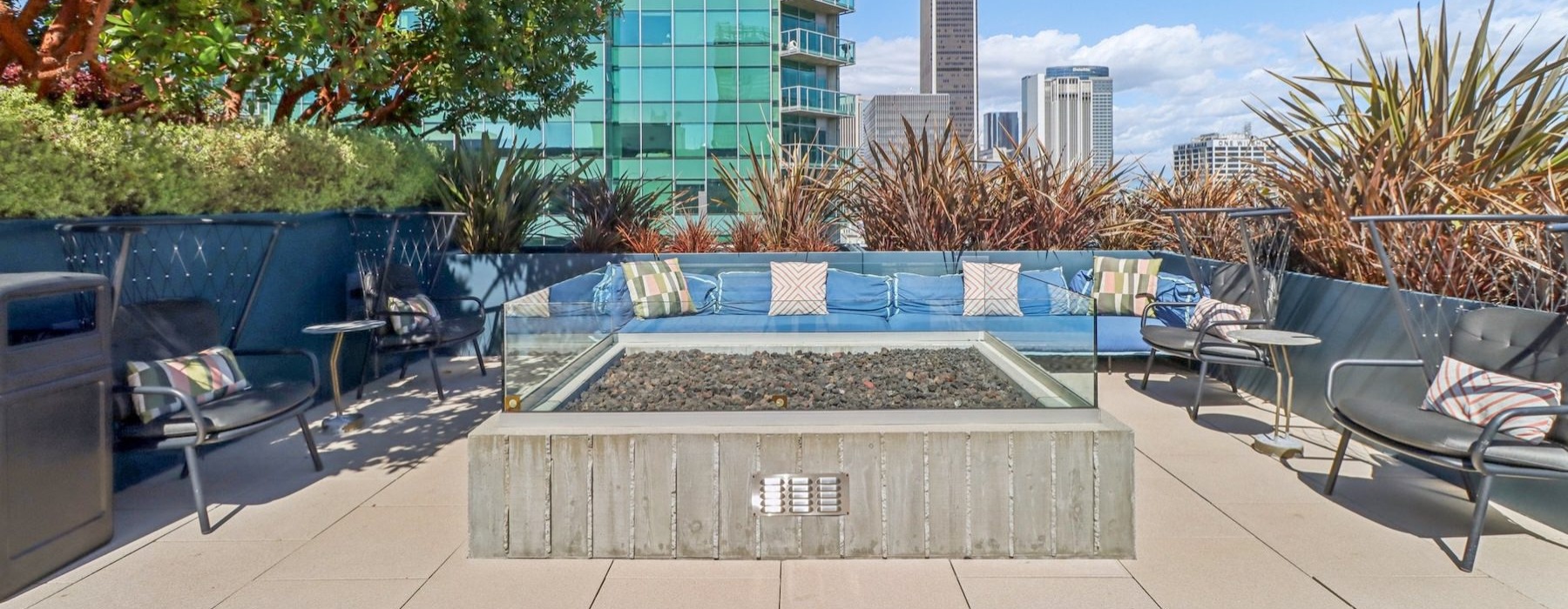 a fire pit with a couch and chairs