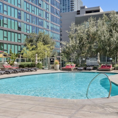 a swimming pool with lounge chairs