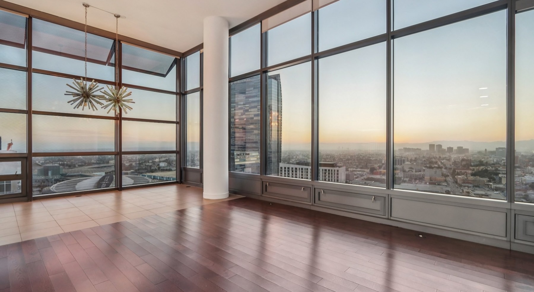 a living room with wood floors and large windows