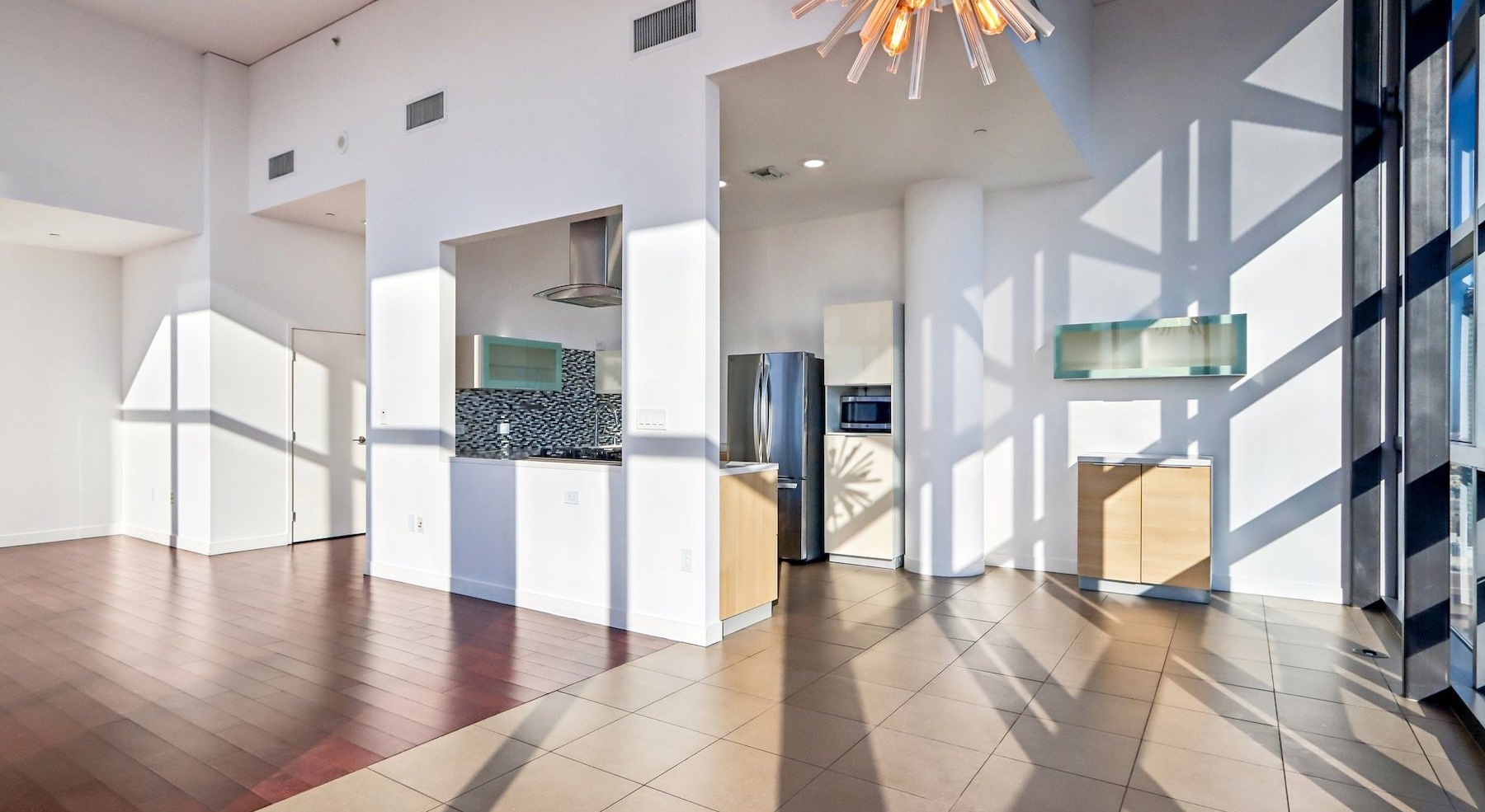 a kitchen and living room with white walls