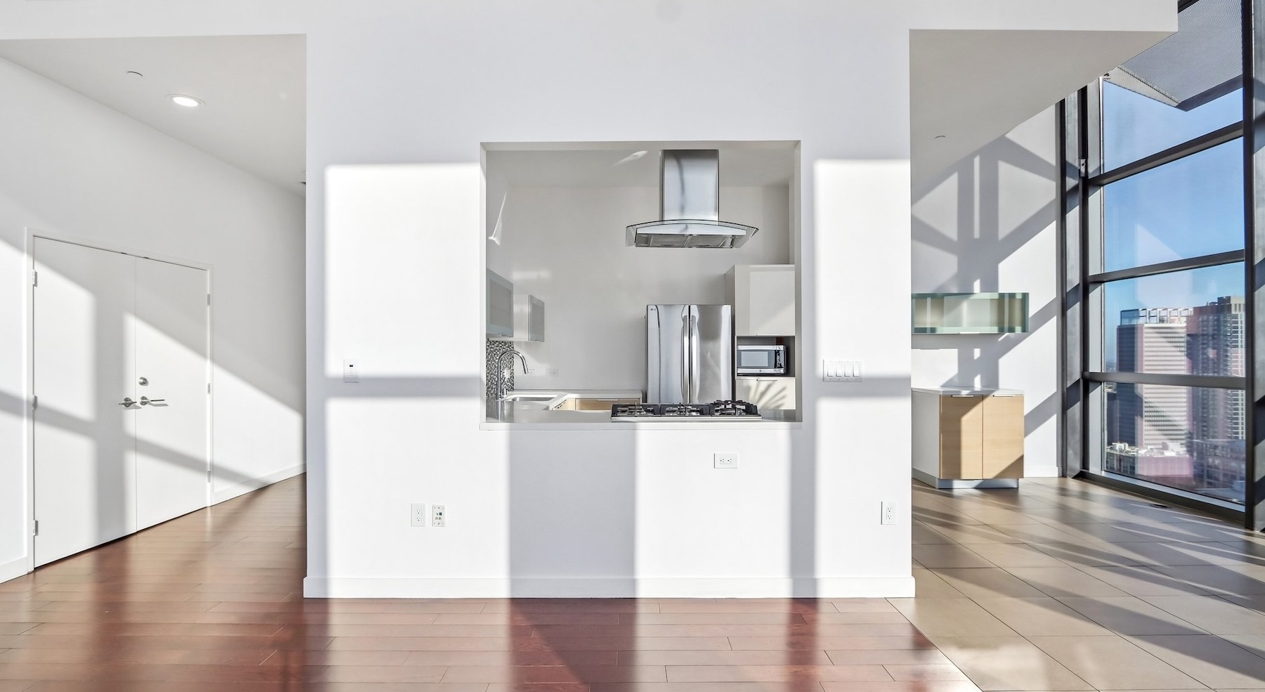 a kitchen and living room with white walls