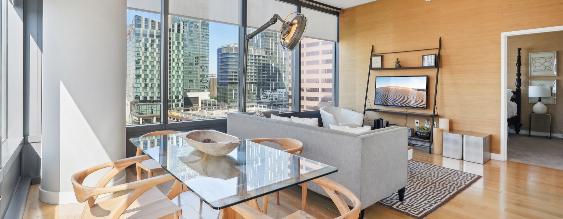 a living room with a table, couch, tv and chairs