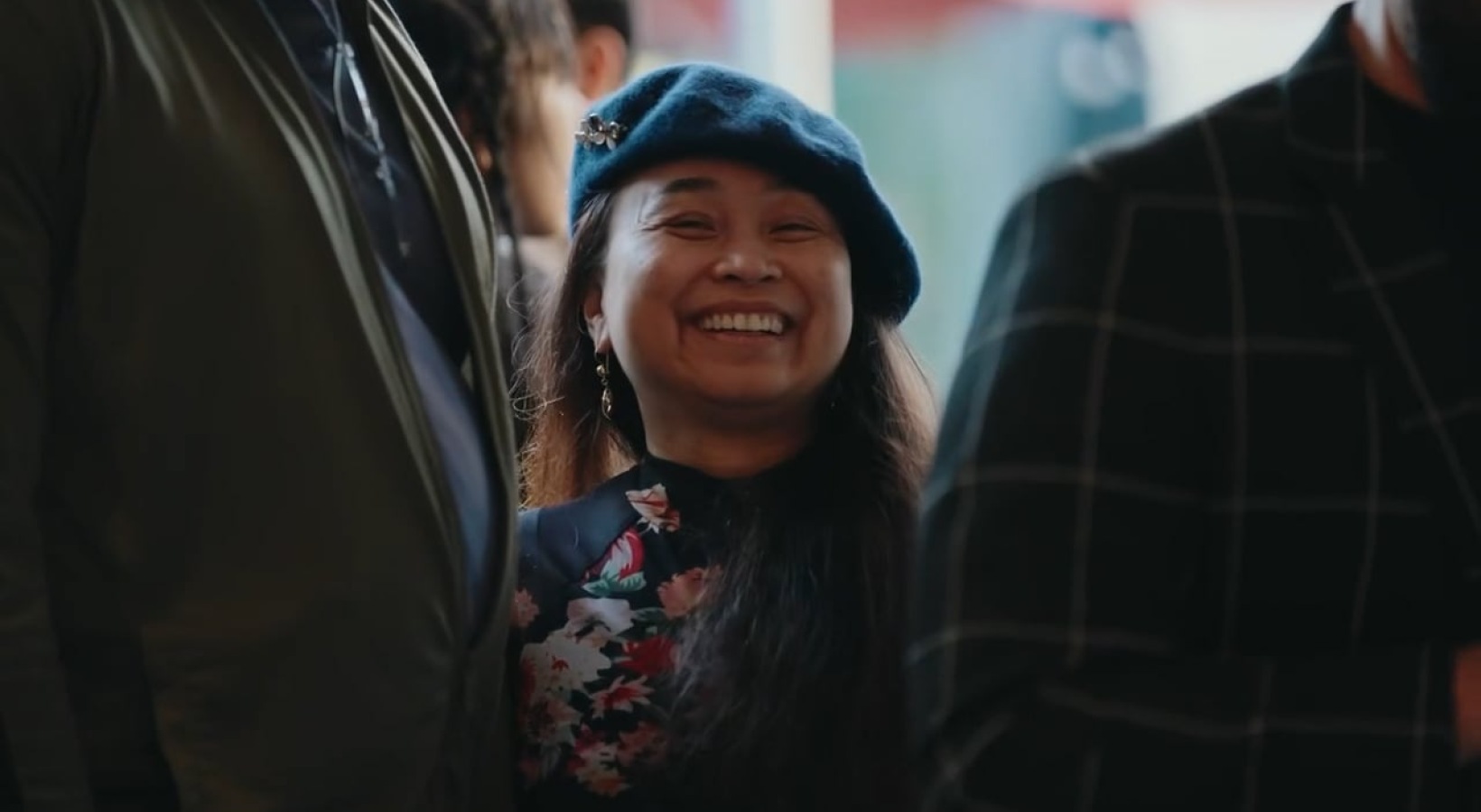 a person smiling in a crowd at an event at Apex and Alina located in Los Angeles, California
